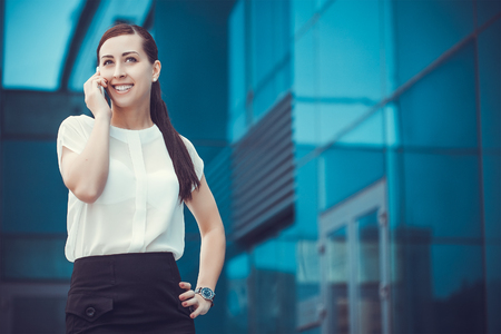 businessman or entrepreneur talking on cellphone. City businesswoman working.の写真素材