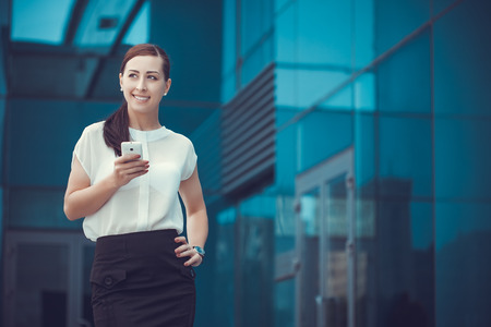 businessman or entrepreneur talking on cellphone. City businesswoman working.の写真素材