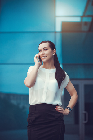 businessman or entrepreneur talking on cellphone. City businesswoman working.の写真素材