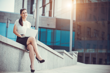 Successful businessman working at laptop. City businesswoman working.の写真素材