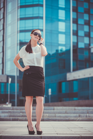 businessman or entrepreneur talking on cellphone. City businesswoman working.の写真素材