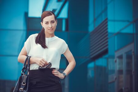 Business woman walking outside in city. office worker in downtown.の写真素材
