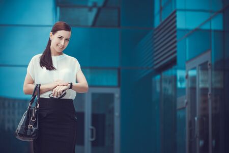 Business woman walking outside in city. office worker in downtown.の写真素材