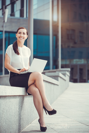 Successful businessman working at laptop. City businesswoman working.の写真素材