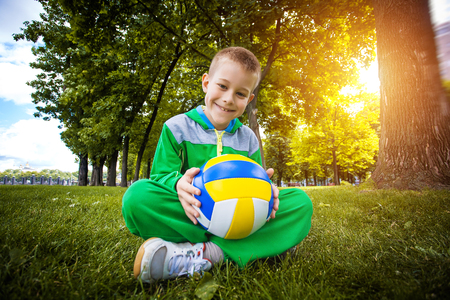 Funny little boy having fun playing soccer with ballの写真素材