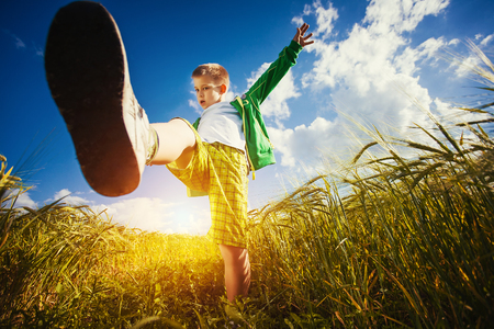 Running little happy kid  meadow weat fieldの写真素材