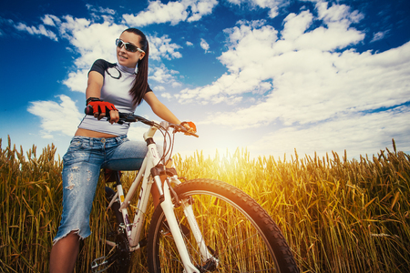 Happy Young Woman riding bicycle outside. Healthy Lifestyle.の写真素材