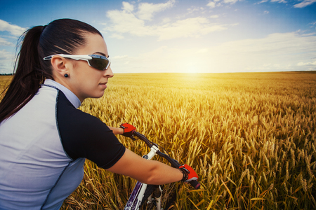 Happy Young Woman riding bicycle outside. Healthy Lifestyle.の写真素材