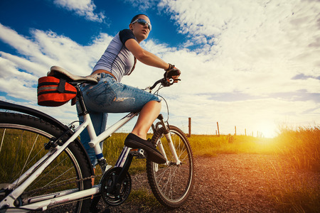 Happy Young Woman riding bicycle outside. Healthy Lifestyle.の写真素材