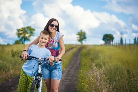 family. mother and son riding  in the parkの写真素材