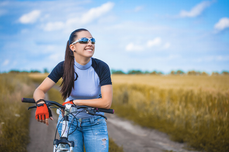 Happy Young Woman riding bicycle outside. Healthy Lifestyle.の写真素材
