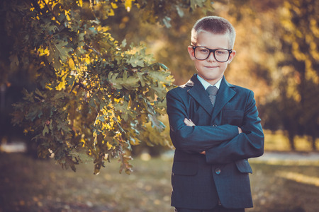 kid businessman with laptop on the park backgroundの写真素材