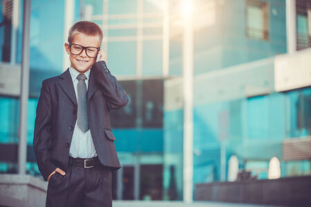 kid businessman talking on the phoneの写真素材