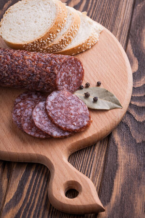 Italian salami sliced on wooden tableの写真素材