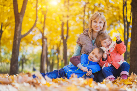 family have fun in the autumn parkの写真素材