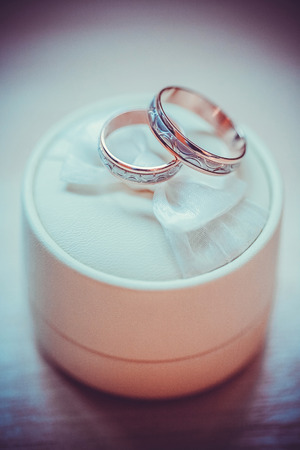 Two wedding rings with violet backgroundの写真素材