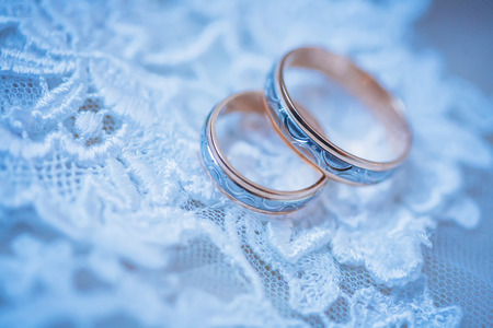 Two wedding rings with violet backgroundの写真素材