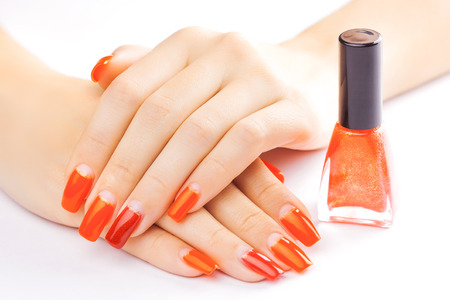manicure. applying red nail polish. isolated on whiteの写真素材