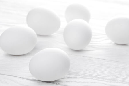 Many white eggs on the wooden tebleの写真素材