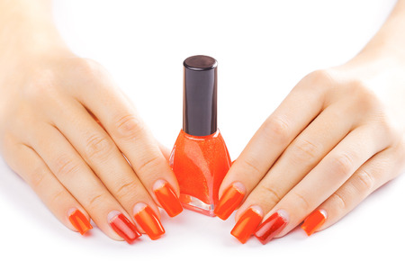manicure. applying red nail polish. isolated on whiteの写真素材
