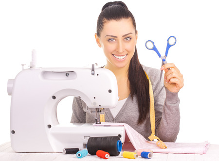 happy seamstress sewing. isolated on the whiteの写真素材