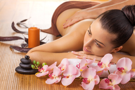 Masseur doing massage on woman body in the spa salonの写真素材