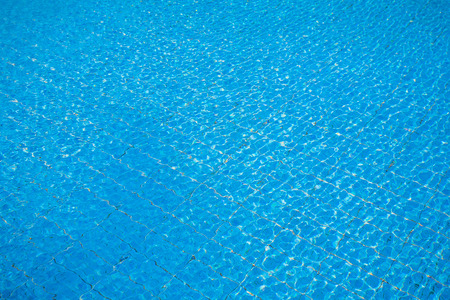 Blue pool water with sun reflectionsの写真素材