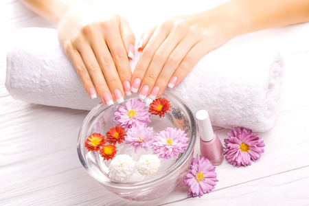 french manicure with colorful chrysanthemumの写真素材