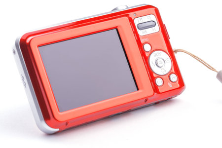 red compact zoom digital camera over whiteの写真素材