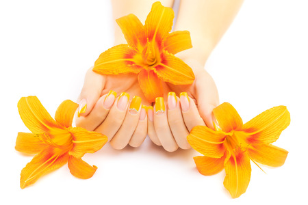 beautiful french manicure with orange lily flowersの写真素材