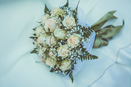 A bridal bouquet on the weddind dressの写真素材