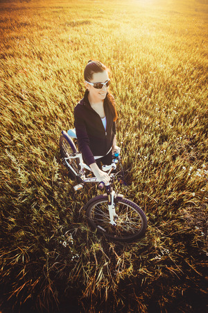 Happy Young Woman riding bicycle outside. Healthy Lifestyle. top viewの写真素材