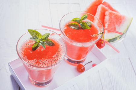 Watermelon smoothie on a white wooden table. Selective focusの写真素材