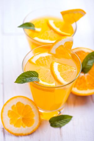 orange alcohol cocktail on a white wooden table.の写真素材
