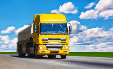 Yellow truck on the sunset highwayの写真素材