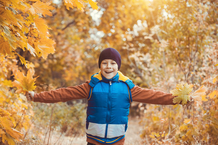 happy kid on a background of autumn treesの写真素材