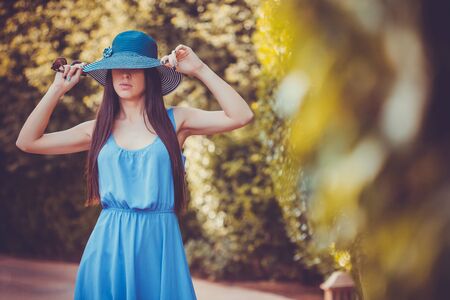 Beautiful young woman in the summer gardenの写真素材
