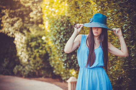 Beautiful young woman in the summer gardenの写真素材