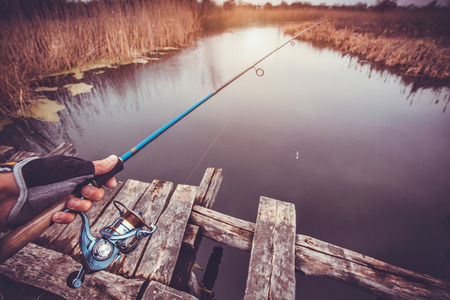 Man holding spinning fishing on the riverの写真素材