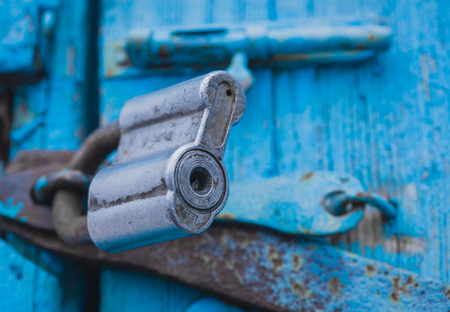 Closeup wooden door with lock. turquoise wooden textureの写真素材