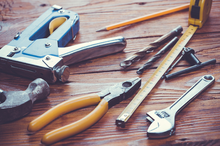 Dirty set of hand tools on a wooden panelの写真素材