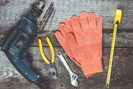 Dirty set of hand tools on a wooden panelの写真素材