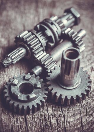 gearwheel of the old engine on the wooden tableの写真素材