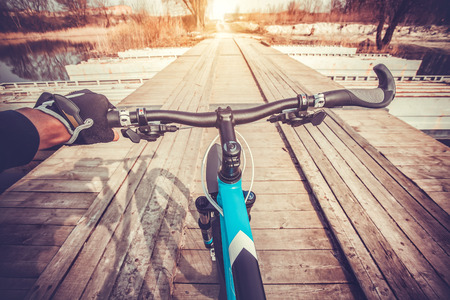 View from bikers eyes during riding on the bridgeの写真素材