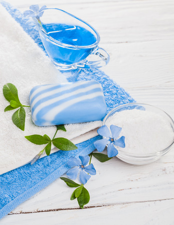 Spa still life of sea salt and essential oils and periwinkle flowersの写真素材