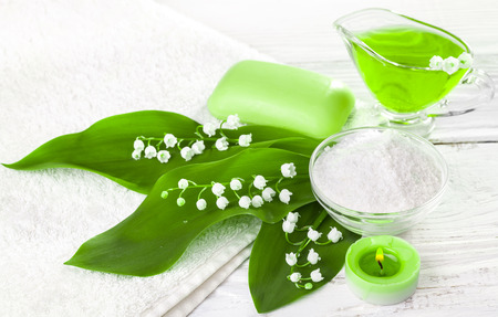 Spa still life of sea salt and essential oils and lily of the valley flowersの写真素材