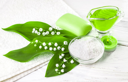 Spa still life of sea salt and essential oils and lily of the valley flowersの写真素材