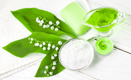 Spa still life of sea salt and essential oils and lily of the valley flowersの写真素材