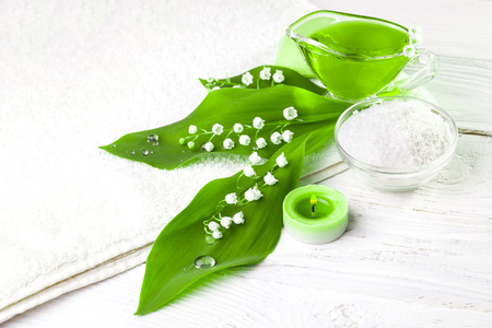 Spa still life of sea salt and essential oils and lily of the valley flowersの写真素材