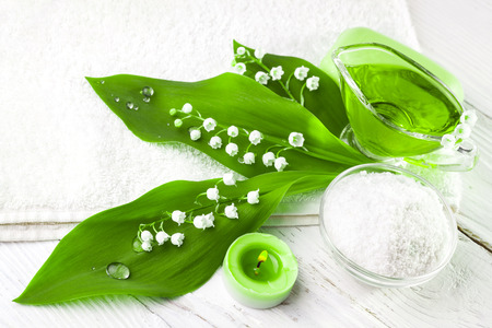Spa still life of sea salt and essential oils and lily of the valley flowersの写真素材